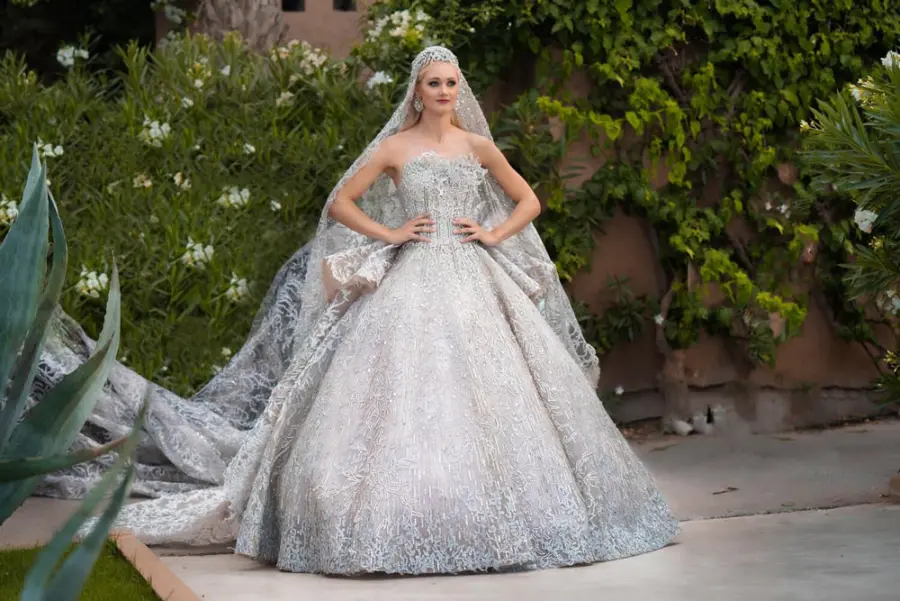 Bride in a couture ball gown and crystal veil in a Marrakech garden - luxury wedding photography Marrakech